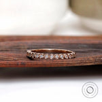 Bezel set round moissanite half eternity band front view