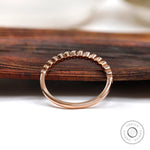 Profile view showing tapered band with bezel set stones