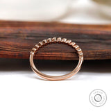Profile view showing tapered band with bezel set stones