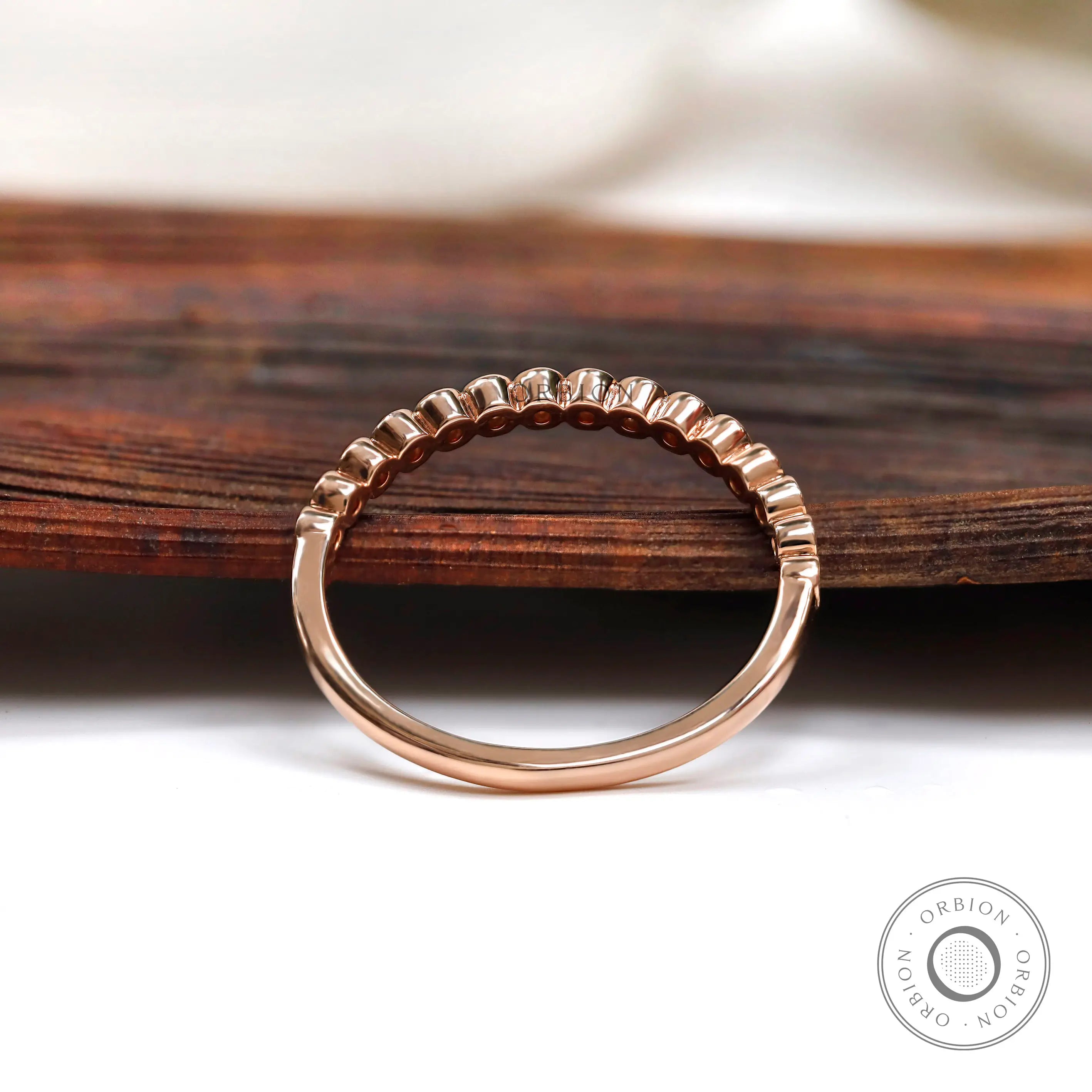 Profile view showing tapered band with bezel set stones