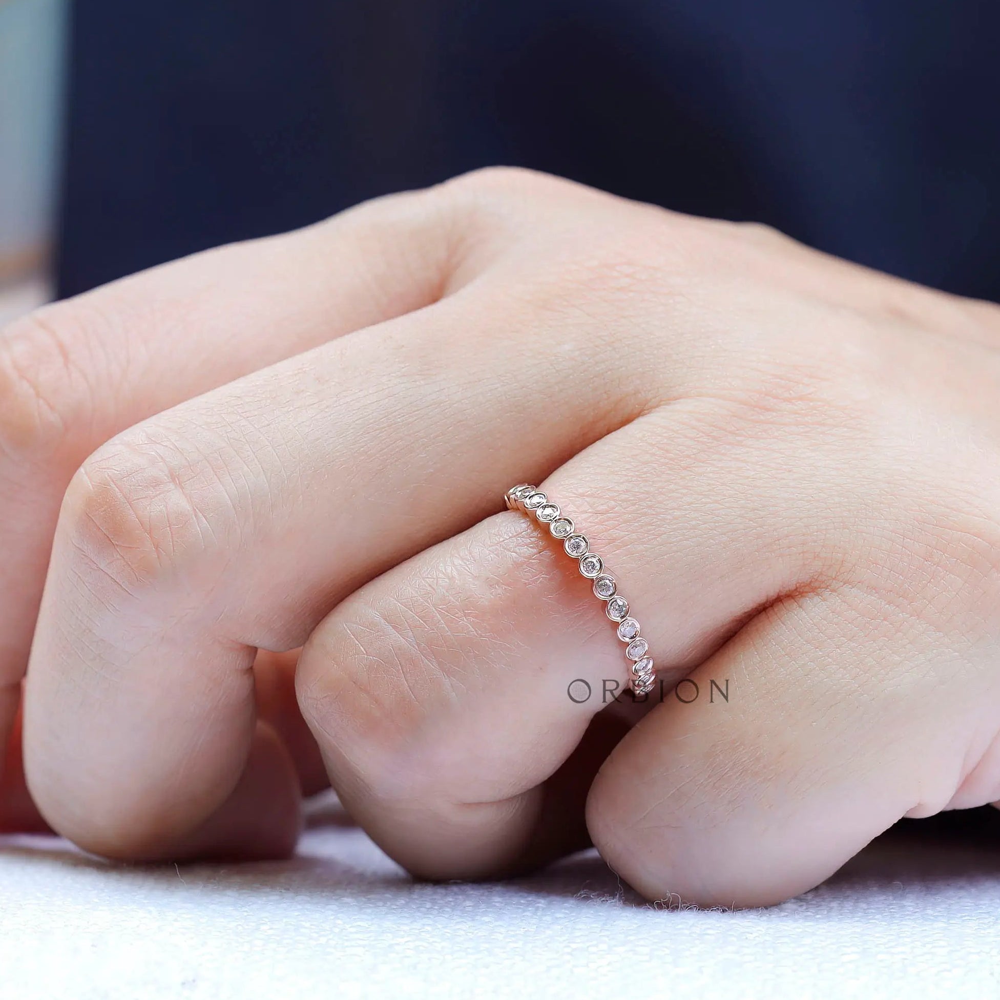 Top view highlighting round bezel set moissanite band