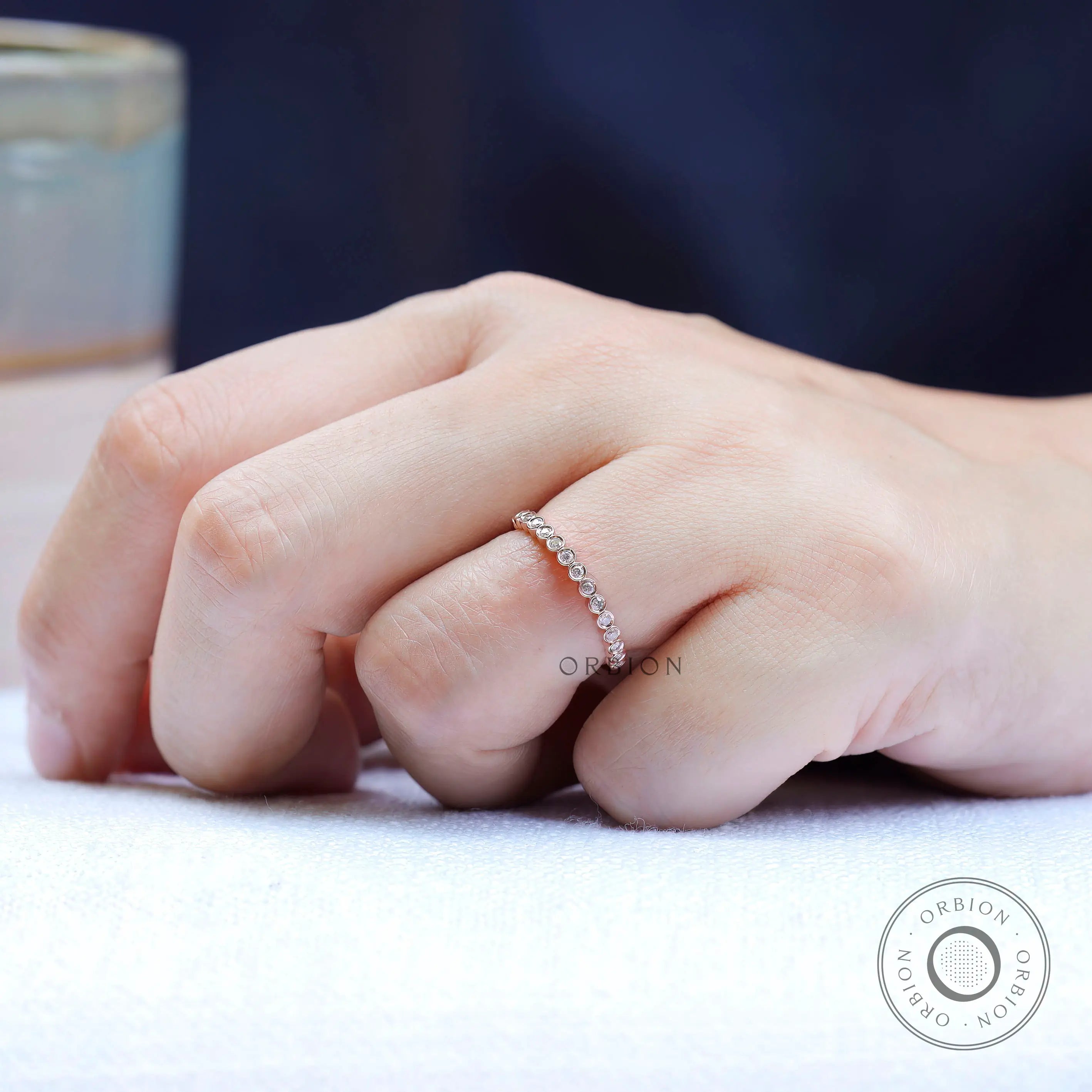 Top view highlighting round bezel set moissanite band