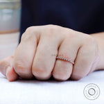 On-hand view of slim bezel set moissanite band worn