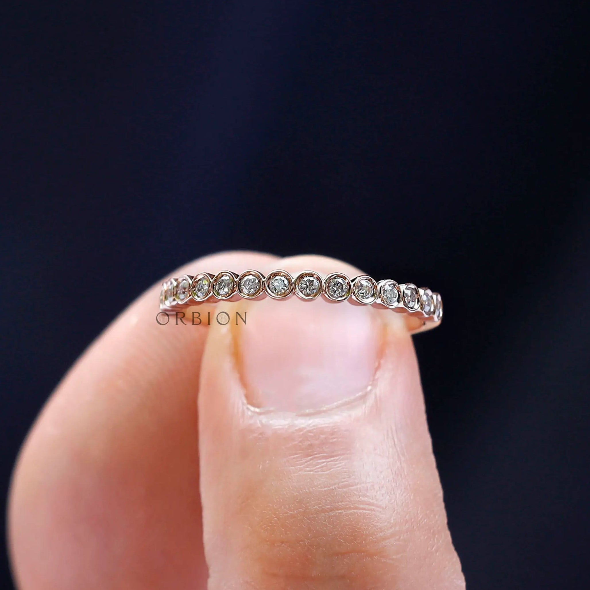 Close-up macro view of round bezel set moissanite stones