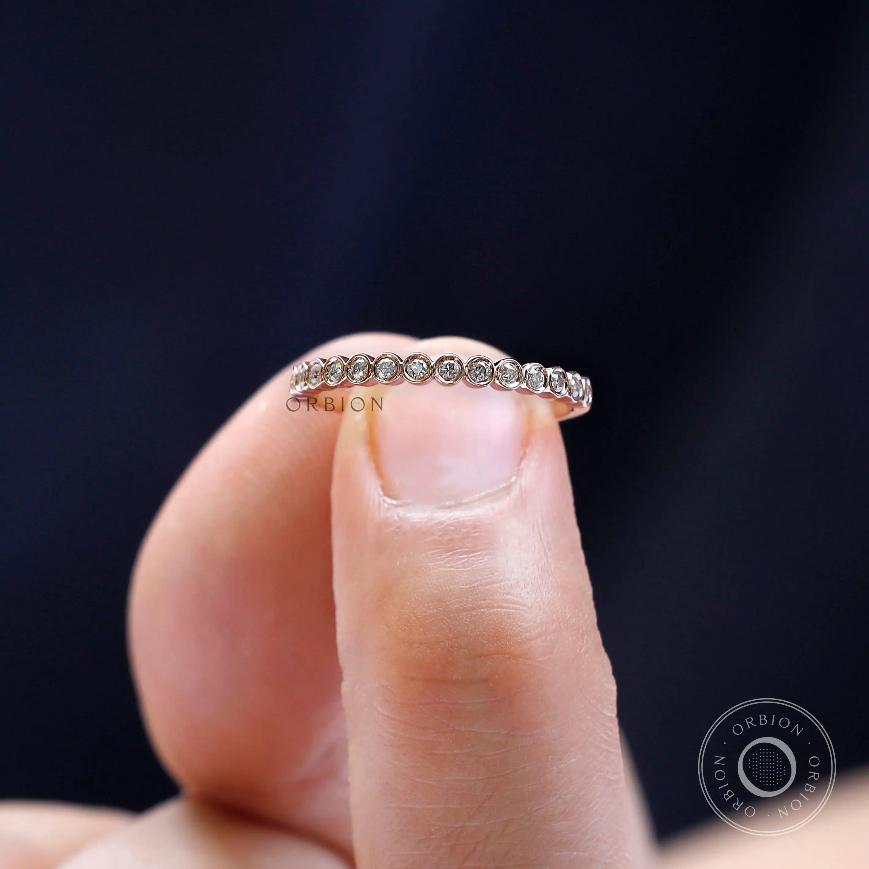 Close-up macro view of round bezel set moissanite stones