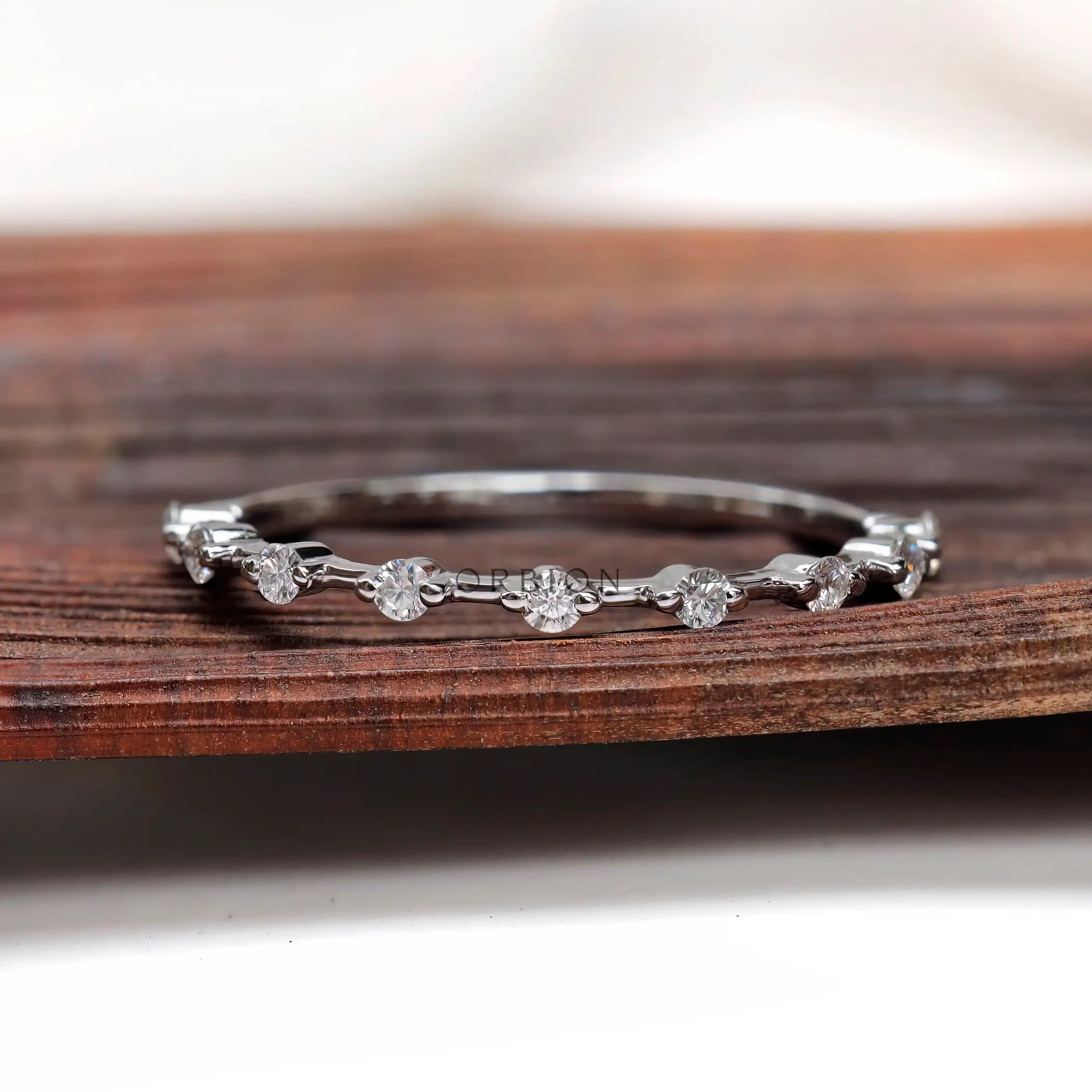 Minimalist floating bubble round half eternity band in white gold, front view