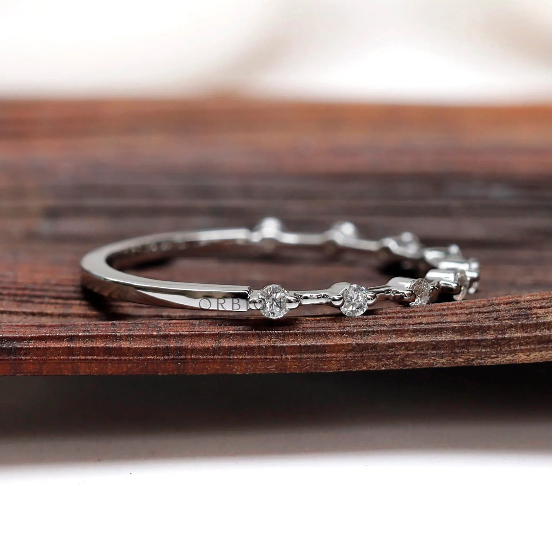 Floating bubble single prong round band in white gold, angled sparkle view