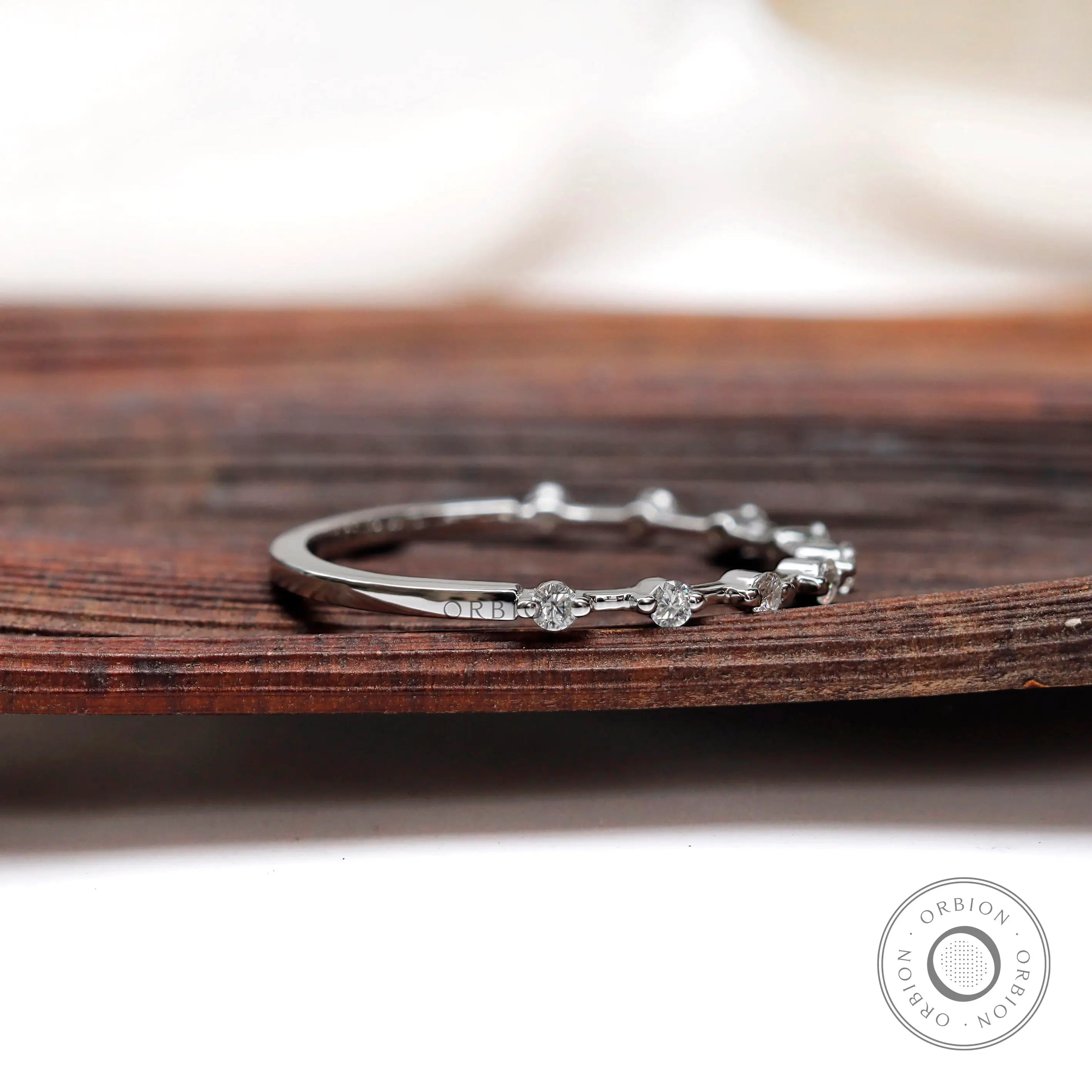 Floating bubble single prong round band in white gold, angled sparkle view