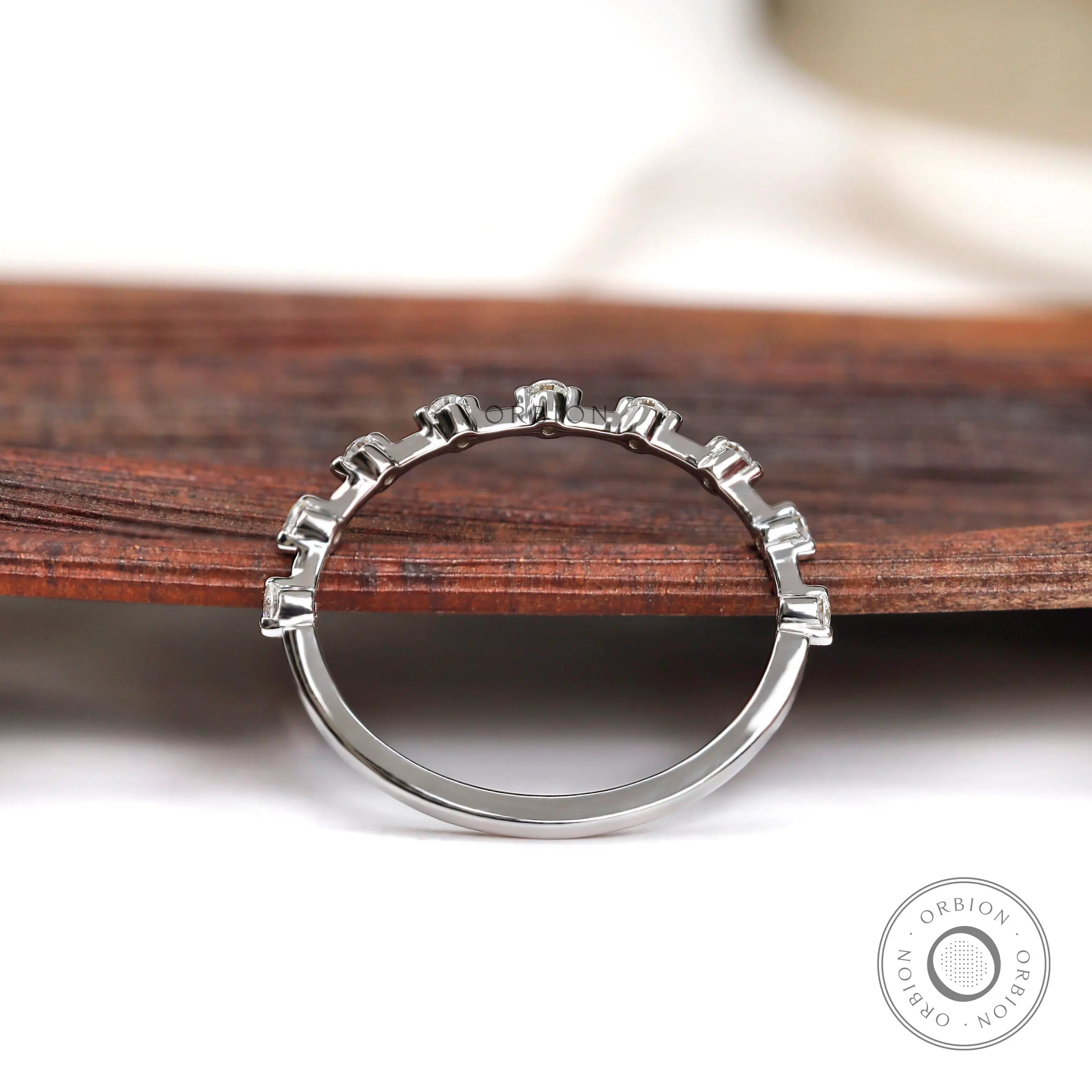 Back view of bubble set round half eternity band in white gold