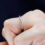 Close-up of single prong round bubble band, delicate half eternity design