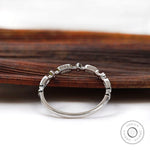 Back profile of slim geometric moissanite wedding band showing band curvature