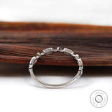 Back profile of slim geometric moissanite wedding band showing band curvature