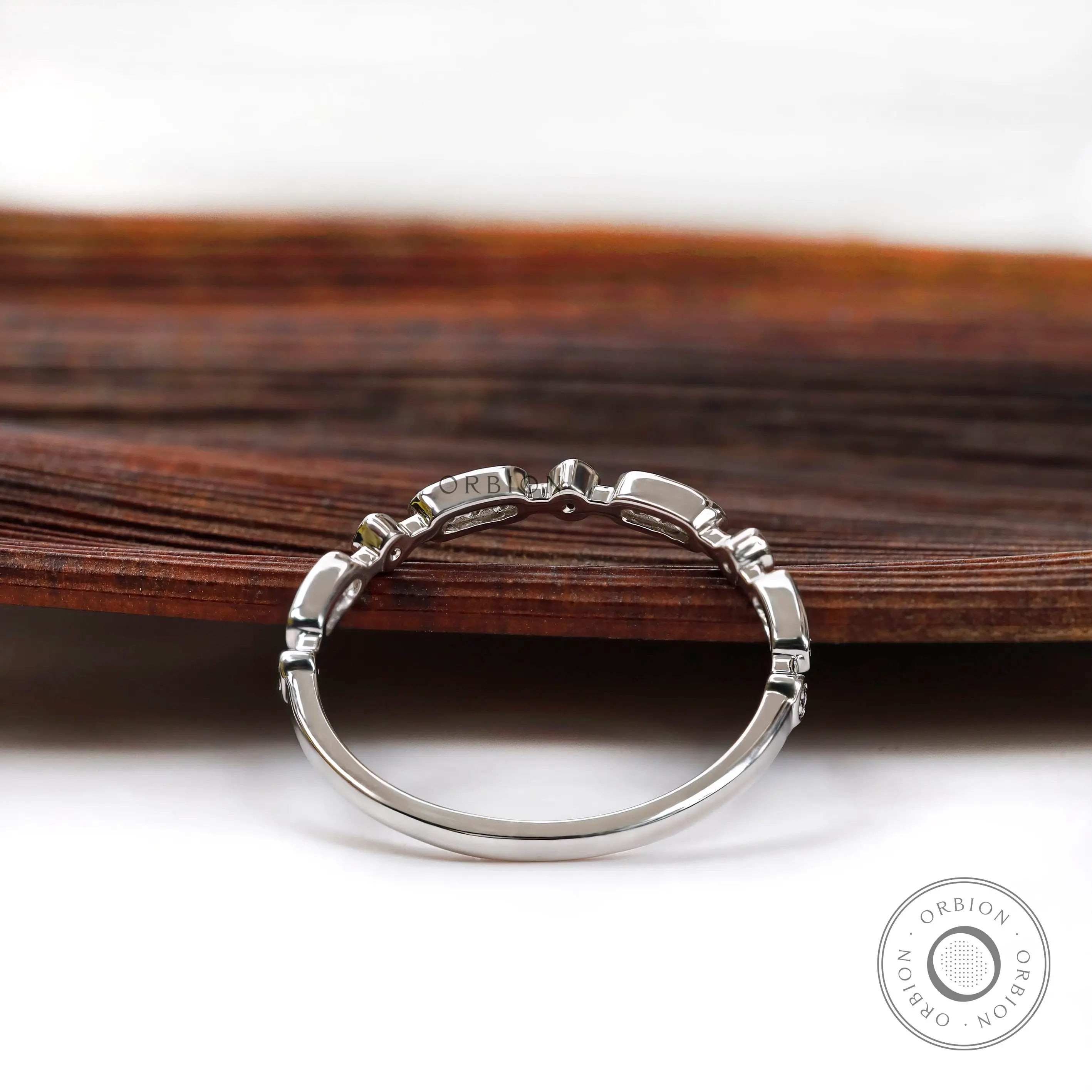 Back profile of slim geometric moissanite wedding band showing band curvature