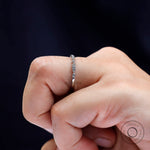 Side angle of geometric moissanite wedding band highlighting bezel details