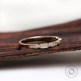 Angled view of geometric hexagon diamond stacking band in solid gold
