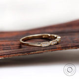 Side profile of dainty hexagon moissanite wedding band