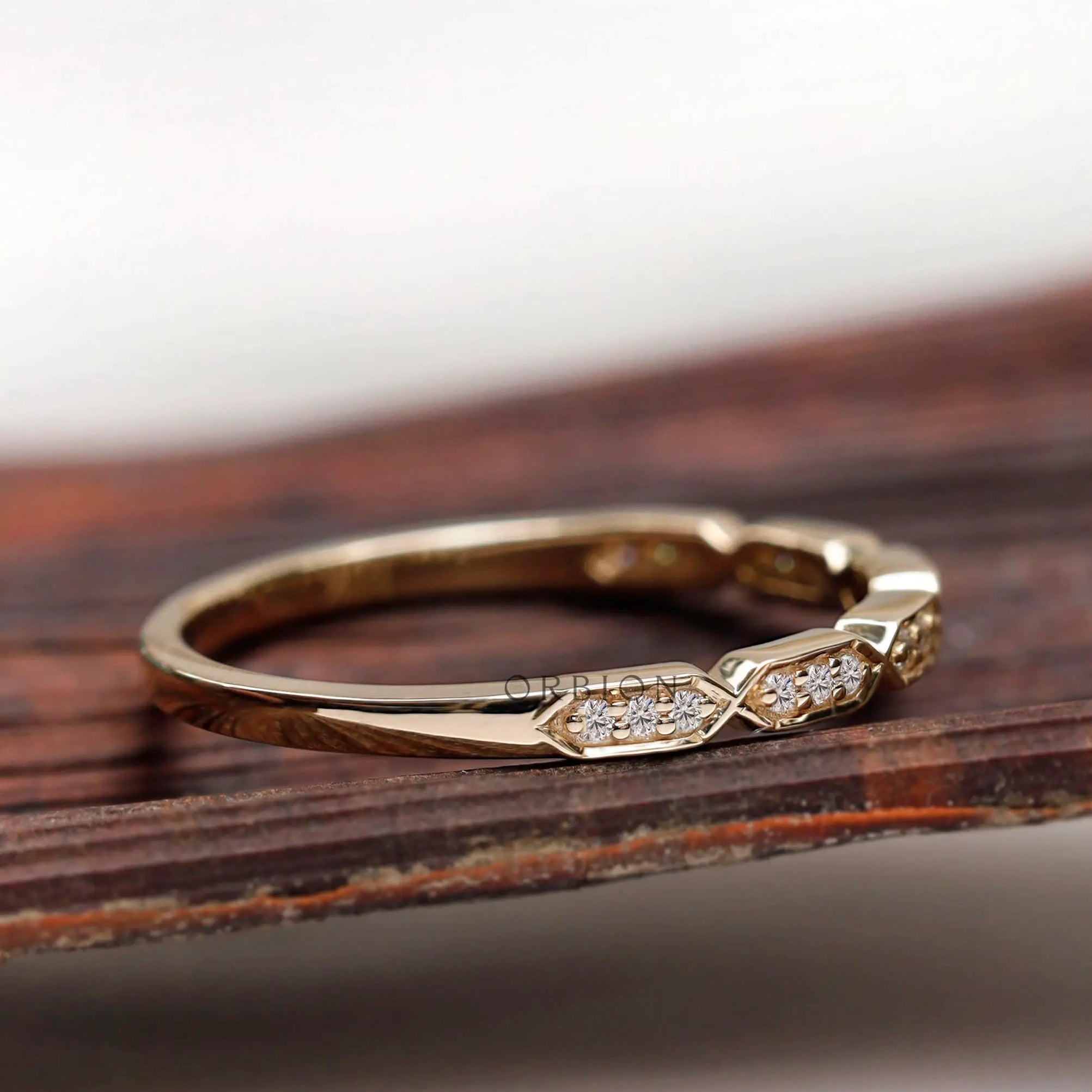 Side profile of dainty hexagon moissanite wedding band