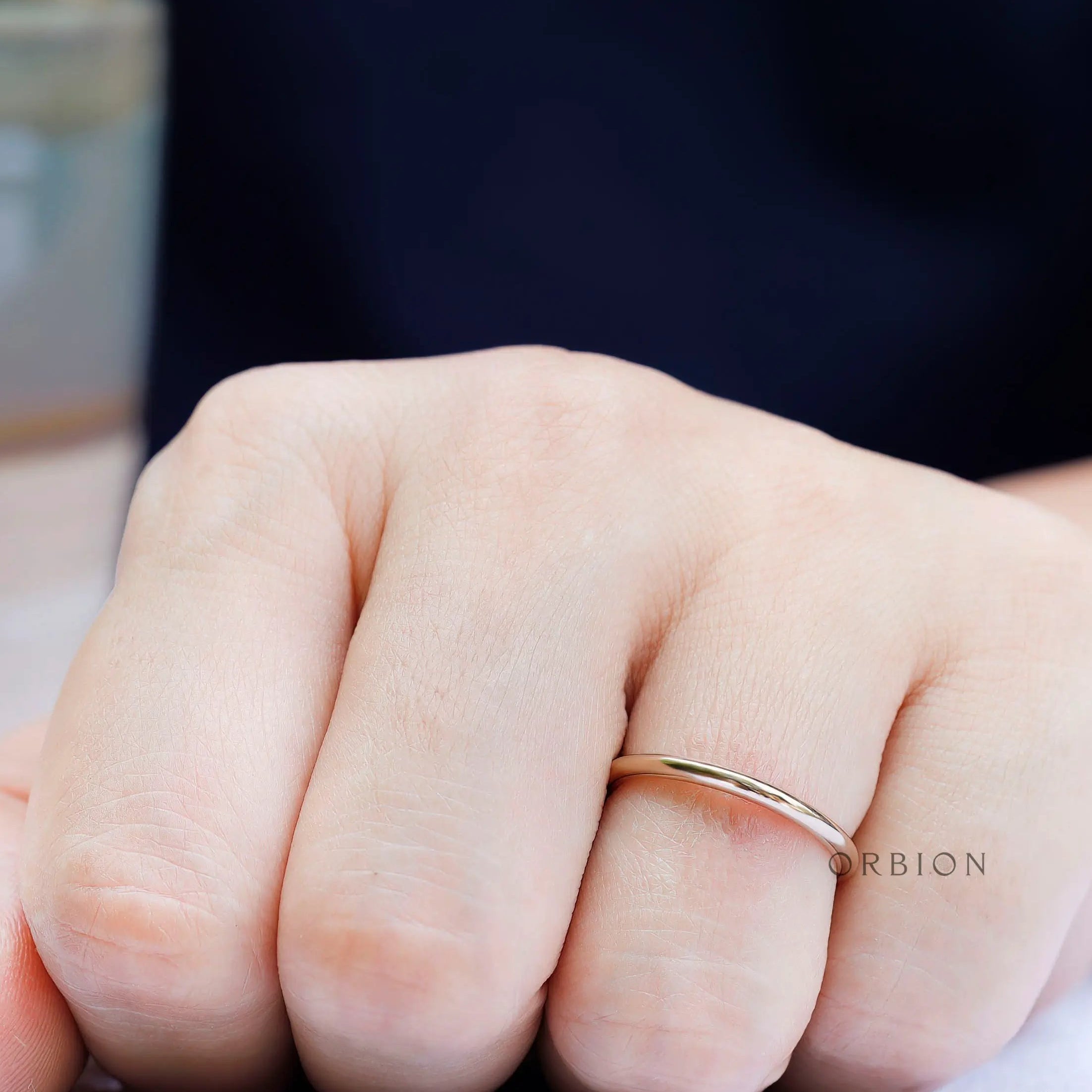 Simple thin plain gold band worn on hand