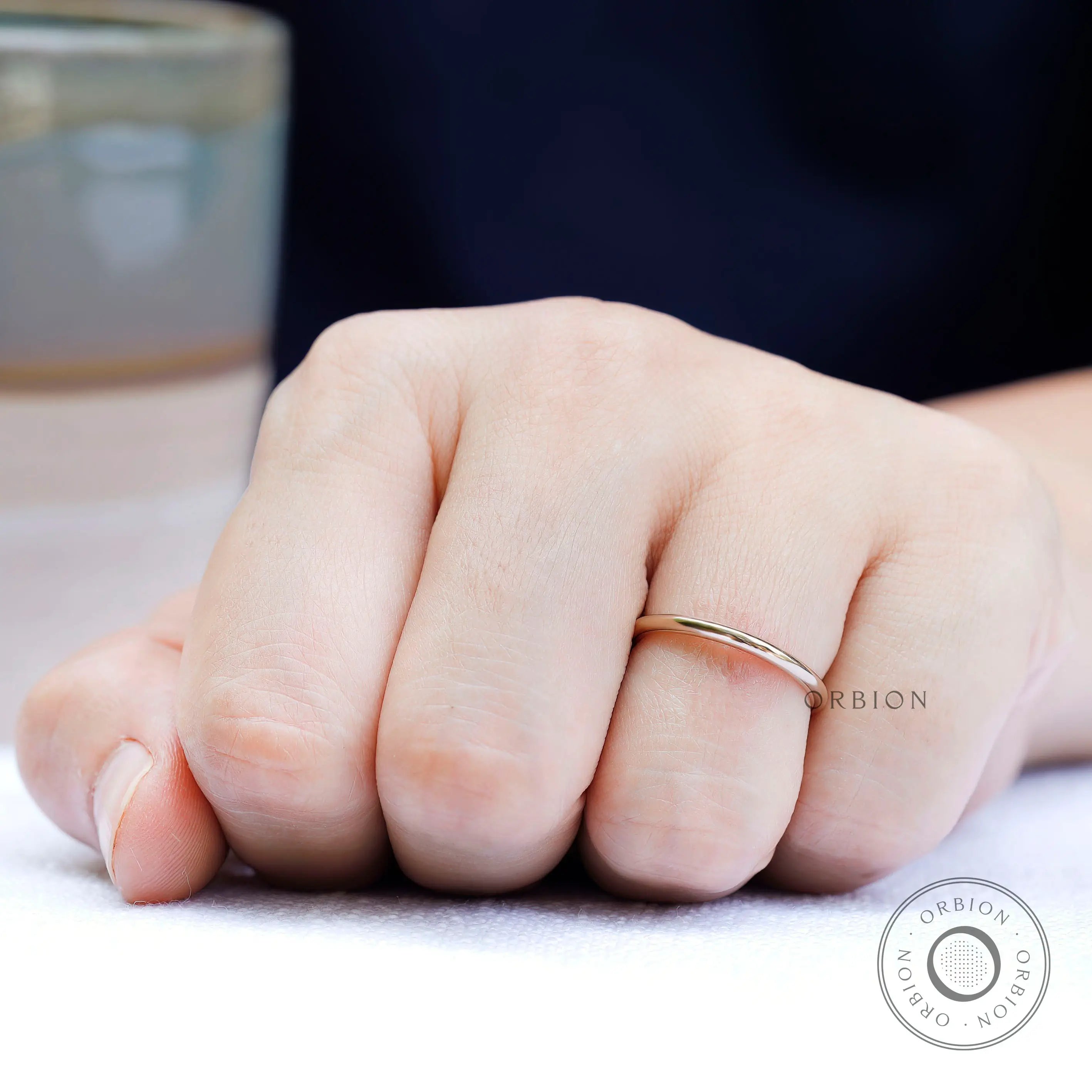 Simple thin plain gold band worn on hand