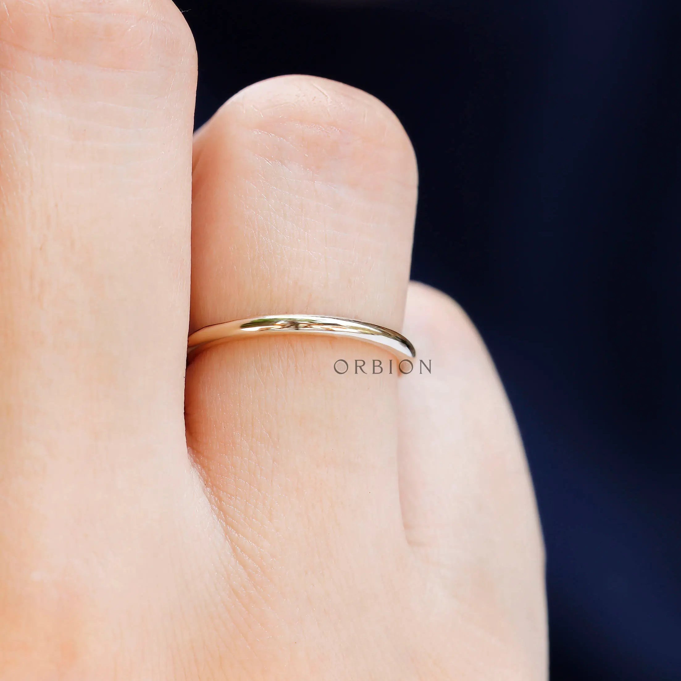 Minimal thin plain yellow gold ring lifestyle view