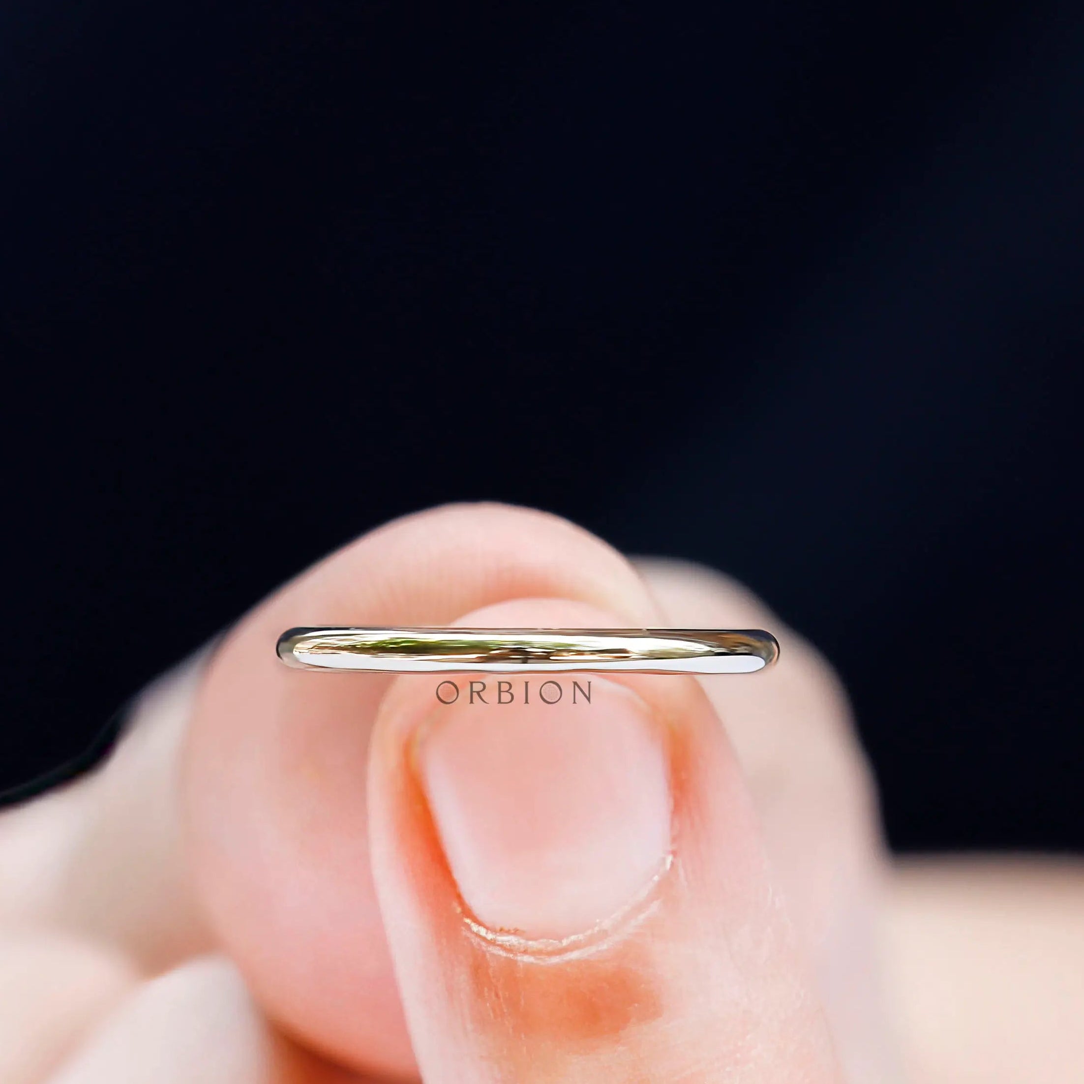Close up of thin plain polished gold band