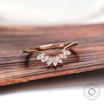Curved nesting band with marquise moissanites in rose gold, front view