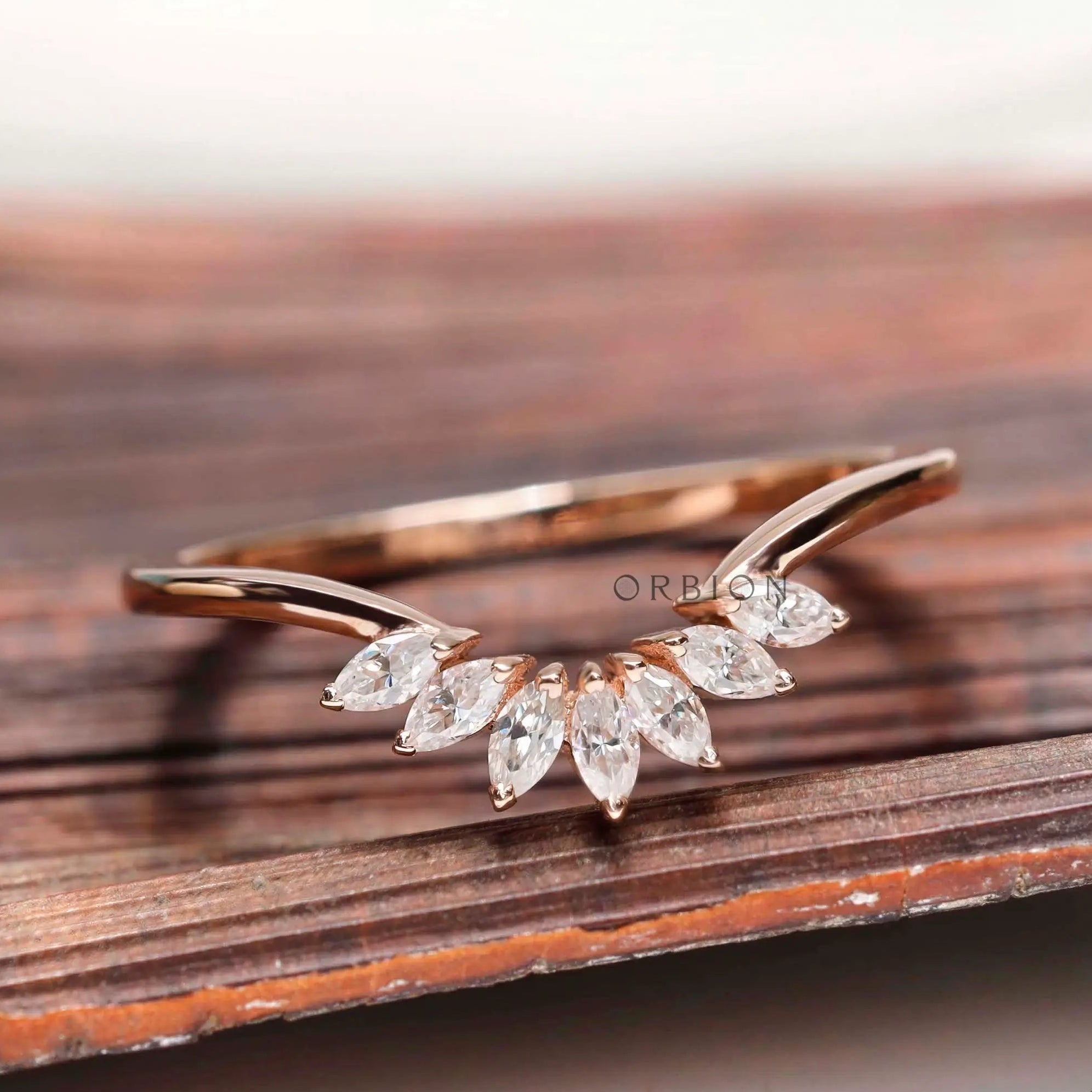 Curved nesting band with marquise moissanites in rose gold, front view