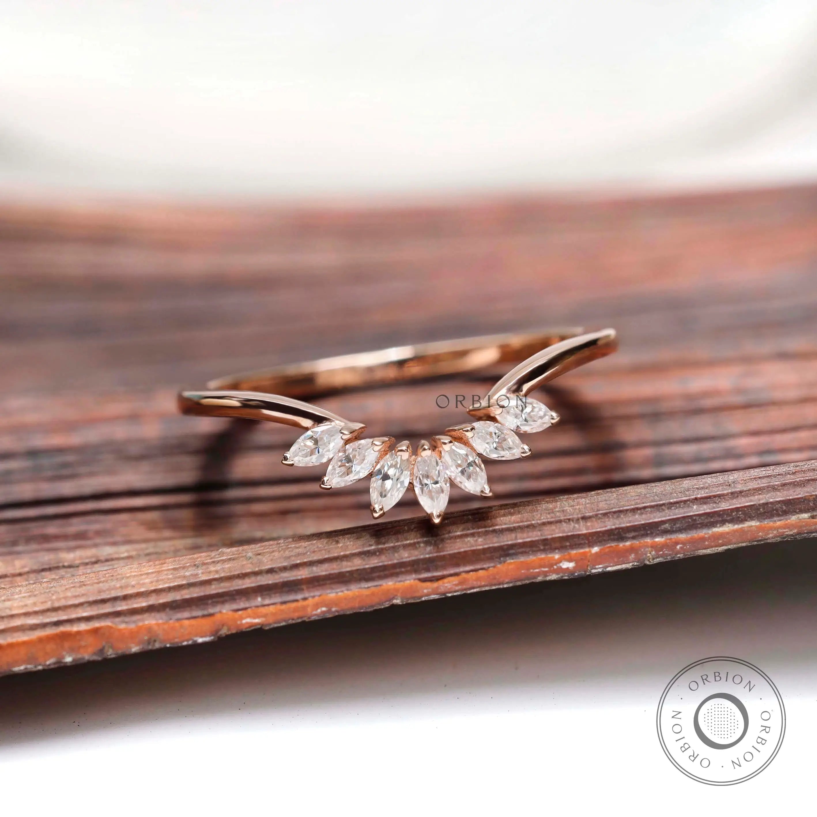 Curved nesting band with marquise moissanites in rose gold, front view