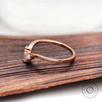 Side profile of curved marquise moissanite nesting band in rose gold