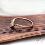Side profile of curved marquise moissanite nesting band in rose gold