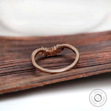 Back view of rose gold curved nesting band with marquise moissanite setting
