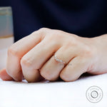 Curved marquise moissanite nesting band worn on hand in rose gold