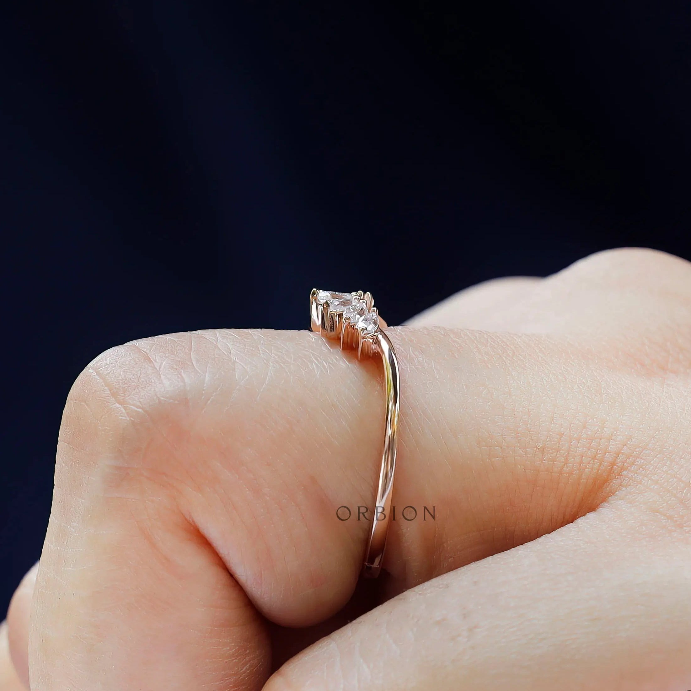 Slim rose gold nesting band with marquise moissanites shown from side angle