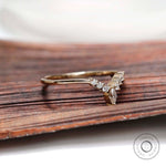 Angled view of chevron contour moissanite band showing marquise center stone detail