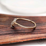 Side profile of marquise and round moissanite V shaped wedding band in solid gold