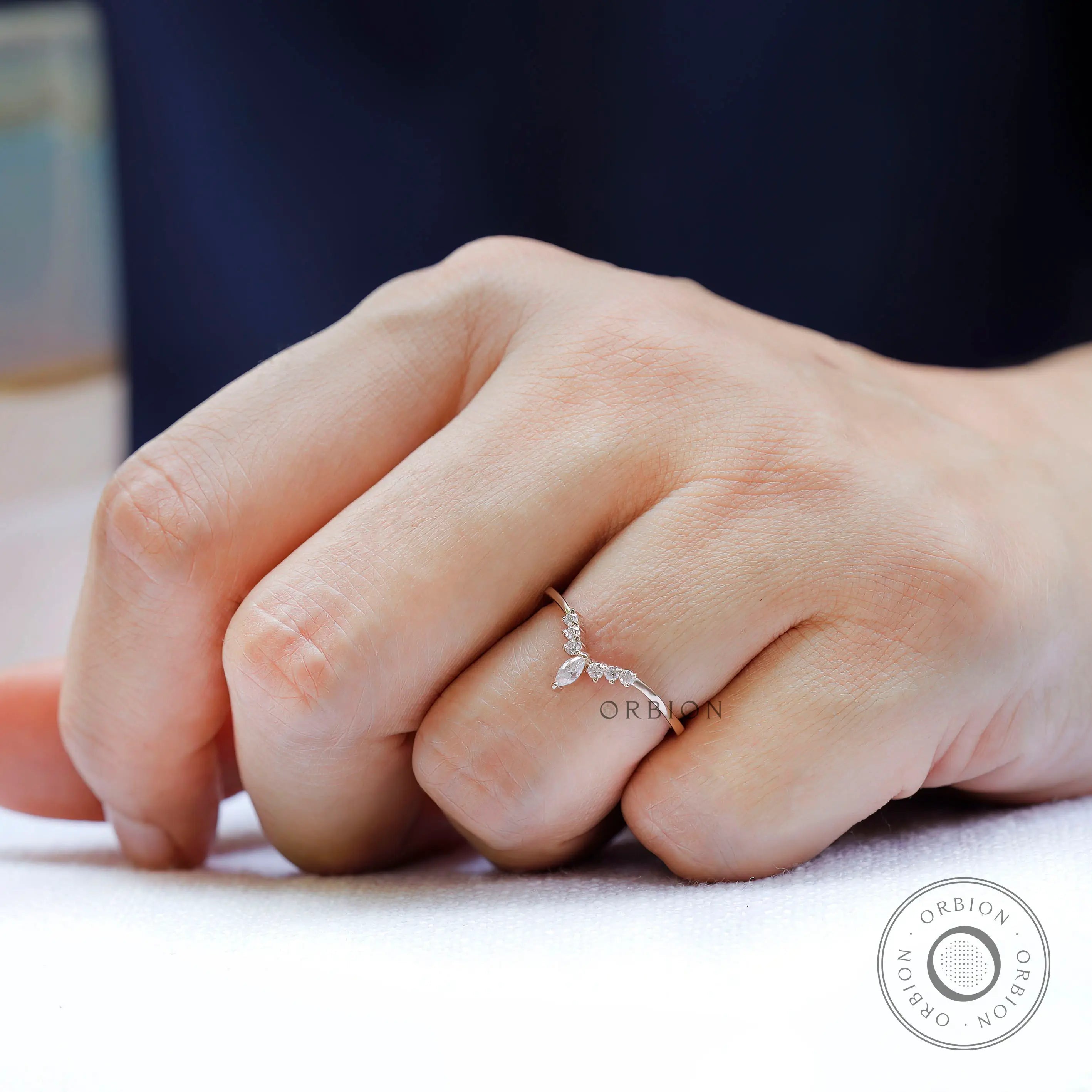 Marquise and round cut moissanite wedding band worn on finger lifestyle view