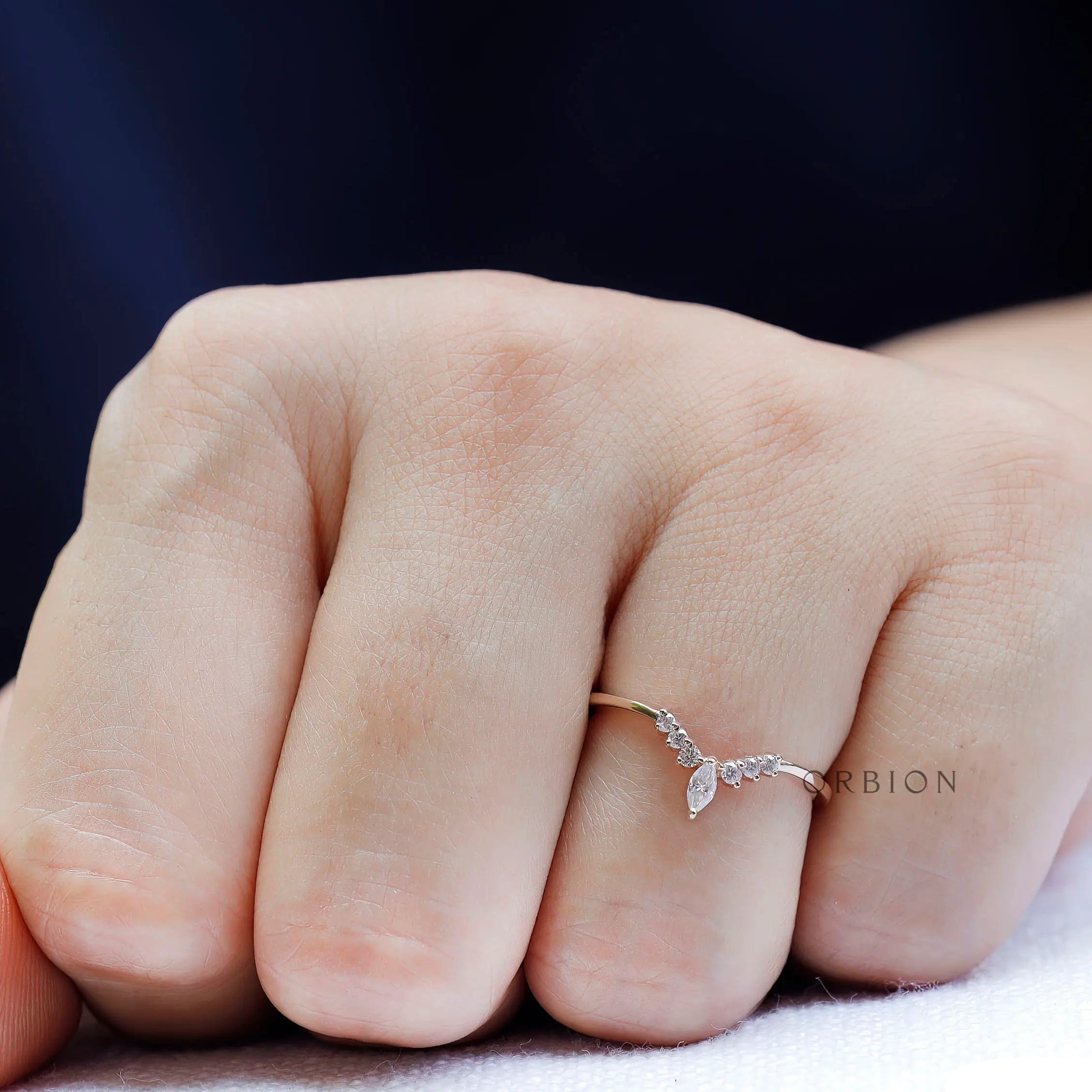 Close up of chevron contour moissanite band highlighting prong setting