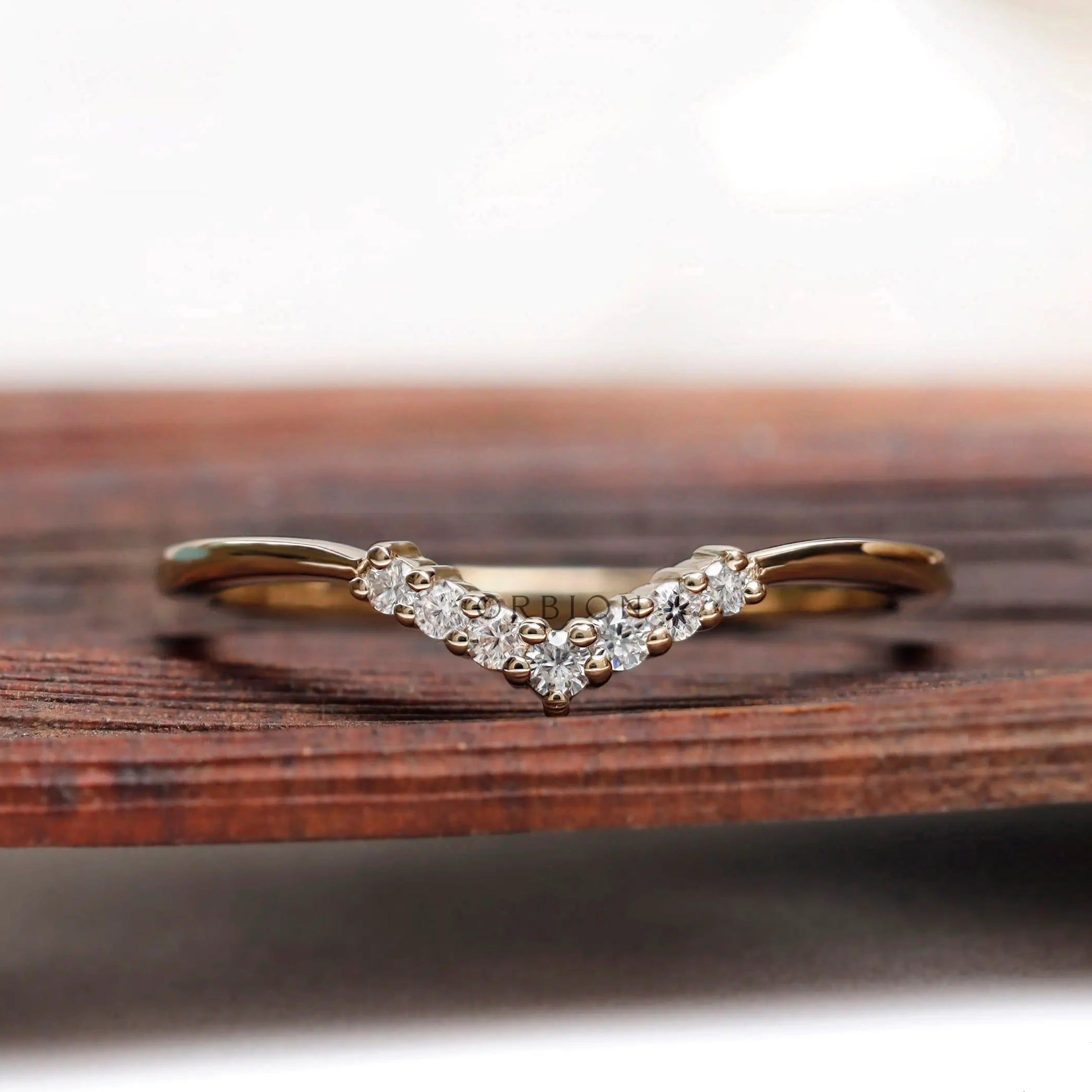 Simple thin chevron moissanite band front view