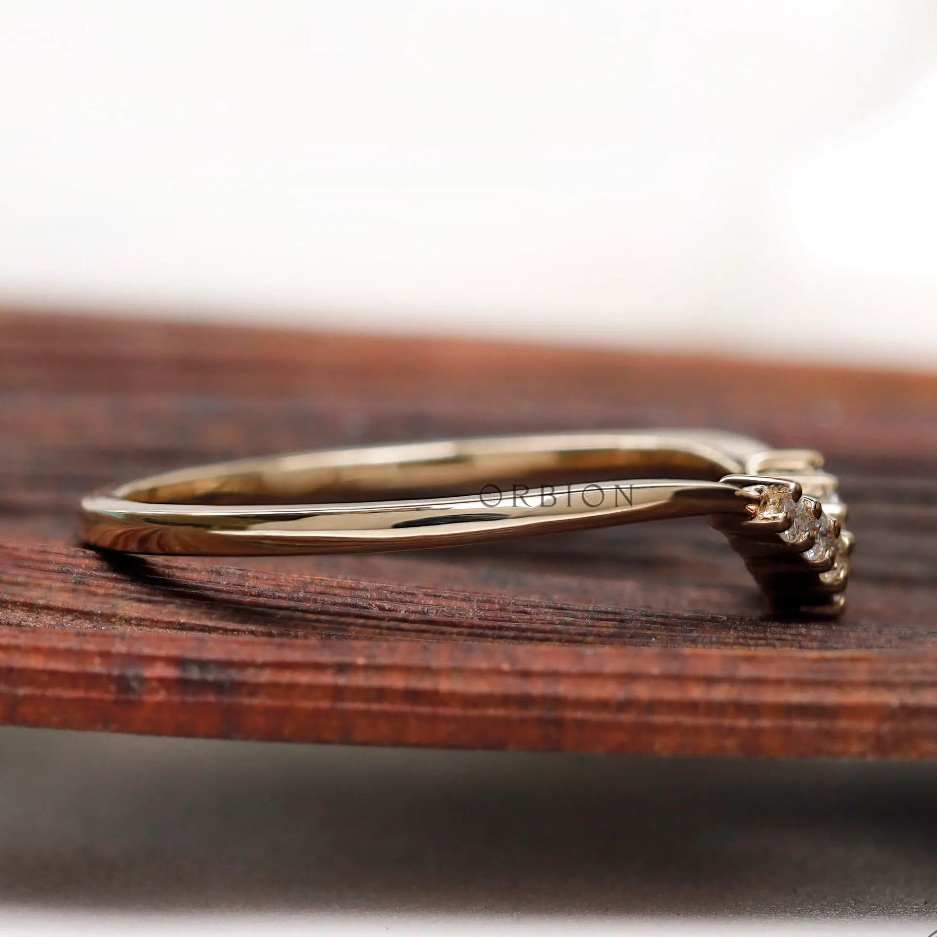 Side profile showing slim yellow gold band