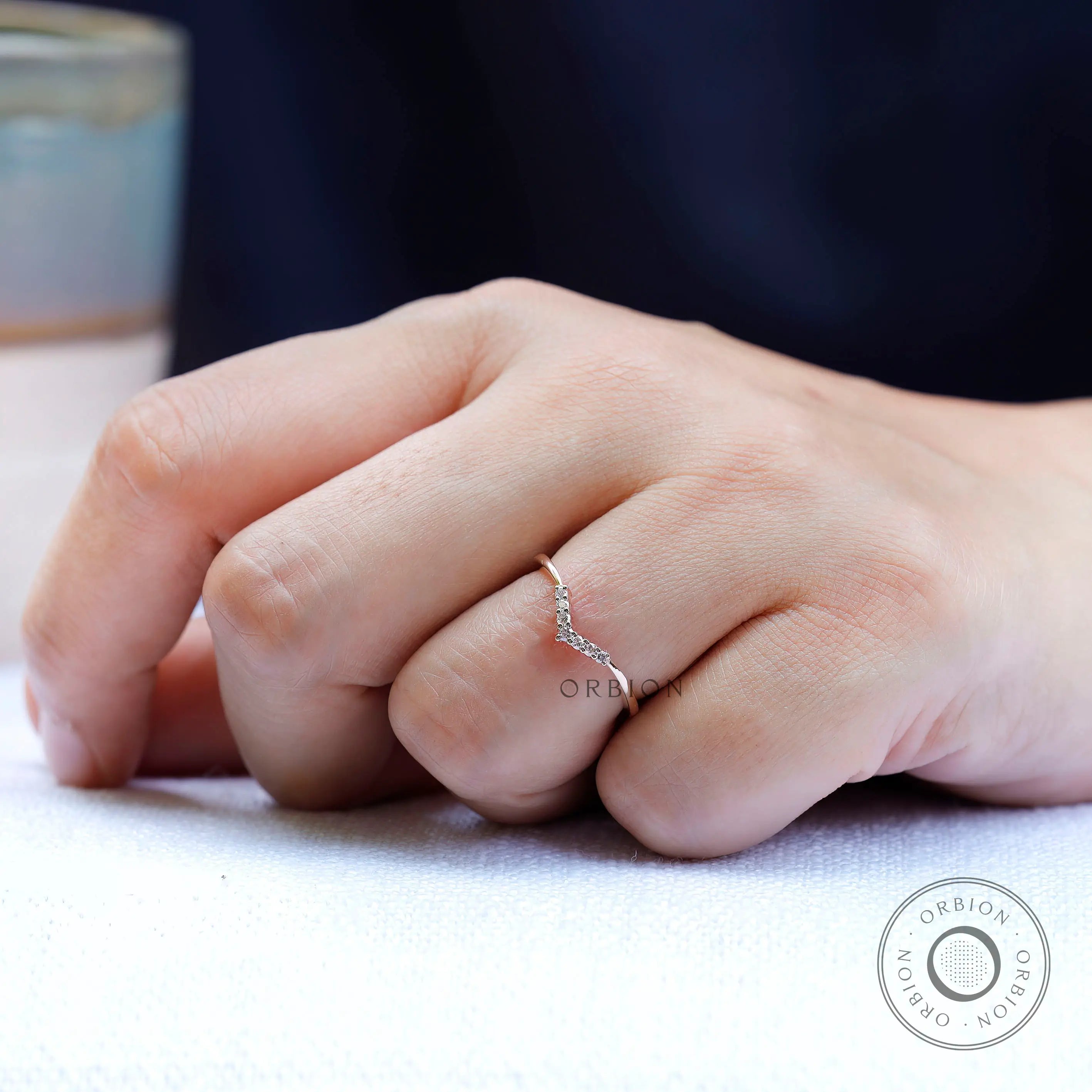 On hand view of thin moissanite chevron ring
