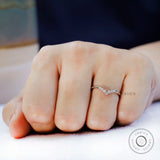 Close up of V shaped moissanite stones showing sparkle detail worn on hand