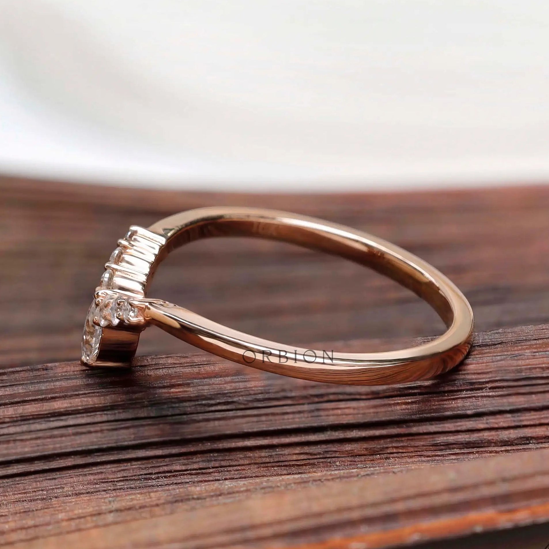 Side profile view showing slim rose gold band and raised marquise setting