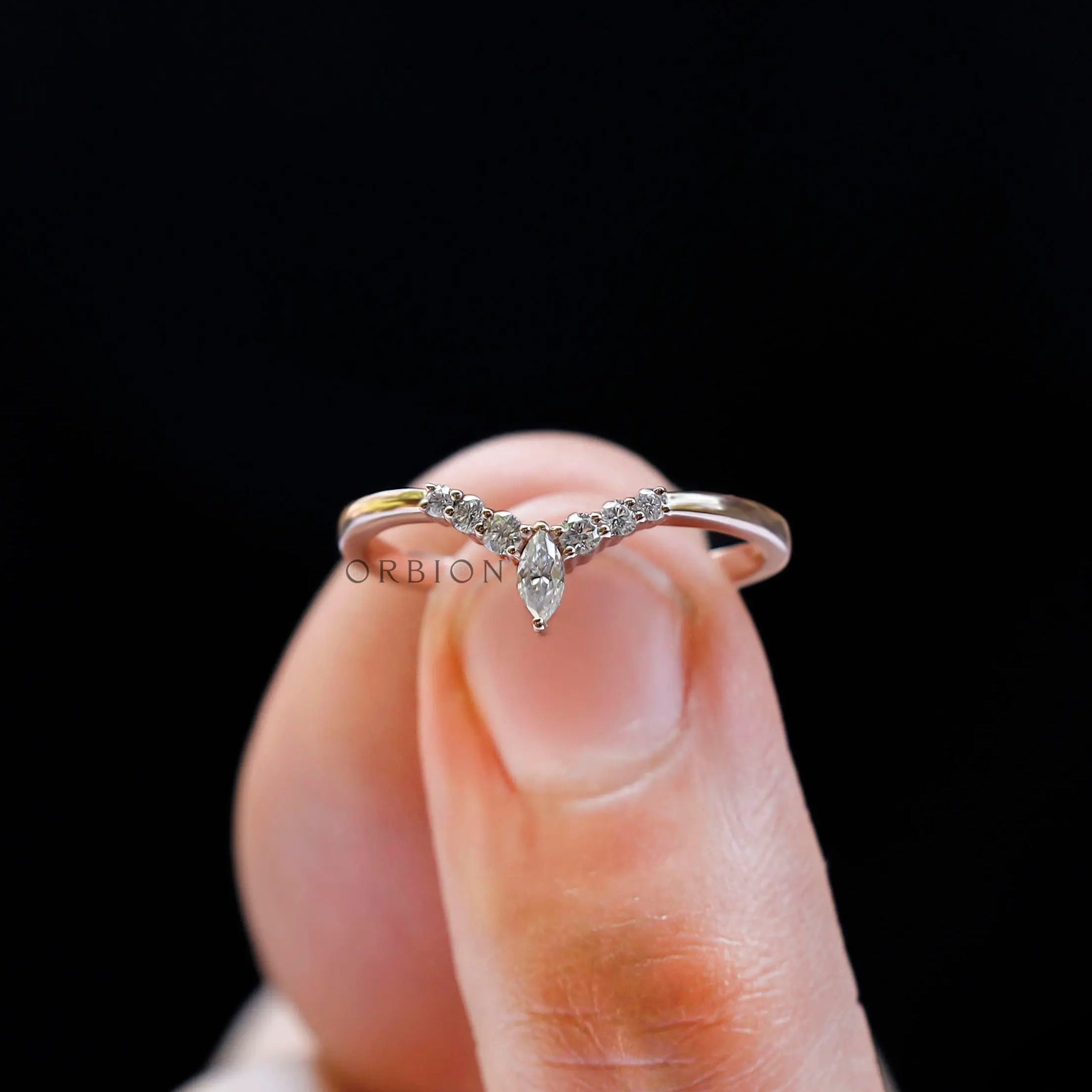 Front close-up view of chevron V-shaped wedding band with marquise center