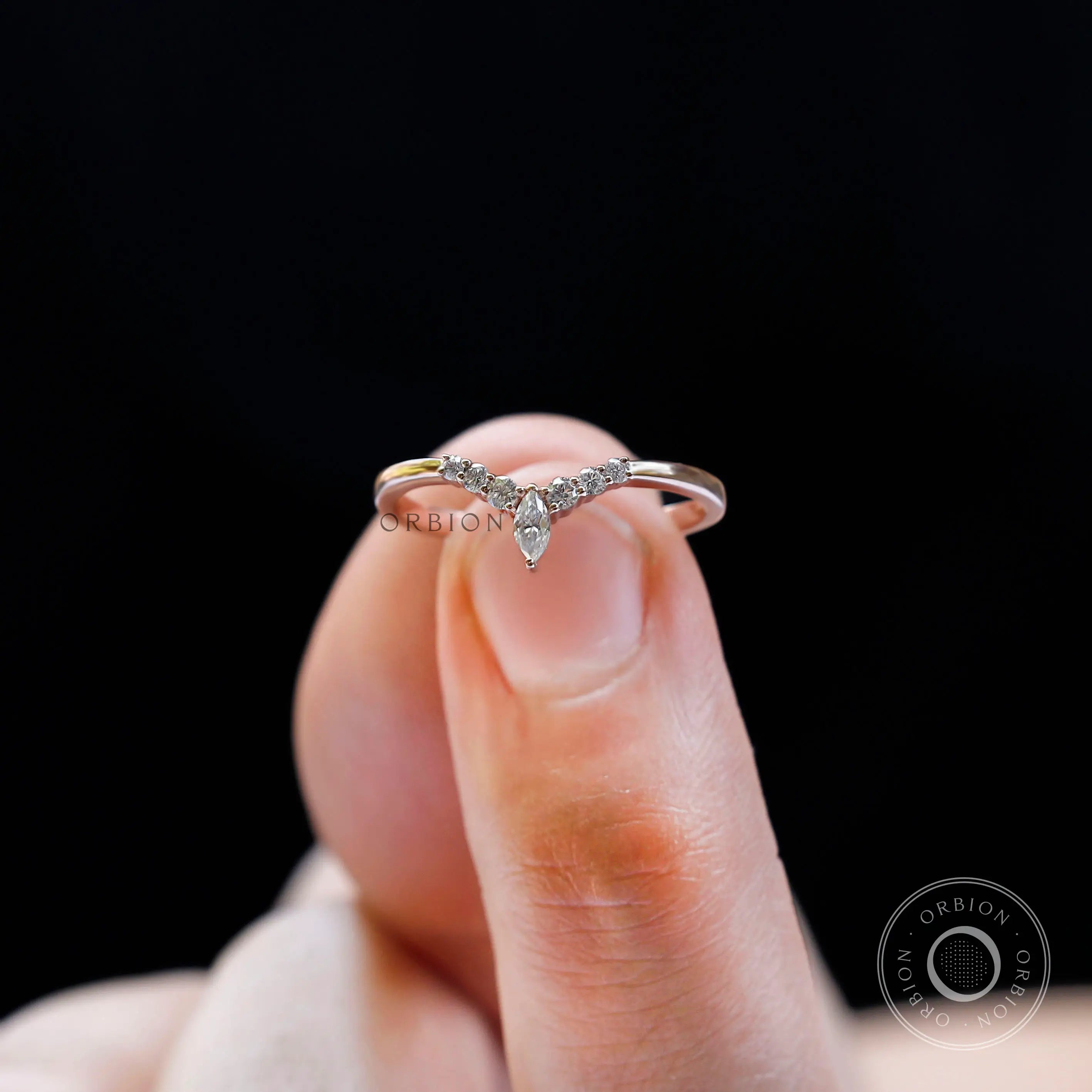 Front close-up view of chevron V-shaped wedding band with marquise center