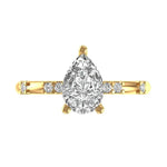Pear cut hidden halo engagement ring in yellow gold