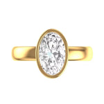 Old mine cut oval bezel set engagement ring in yellow gold