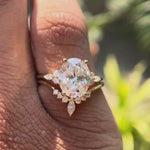 Oval moissanite cluster bridal ring set in 14K yellow gold.