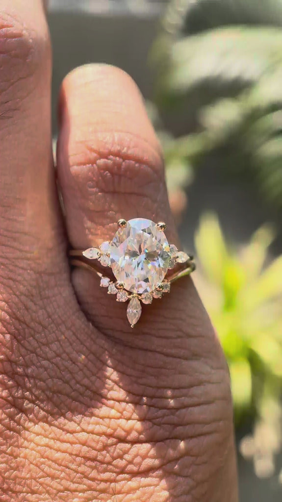 Oval moissanite cluster bridal ring set in 14K yellow gold.