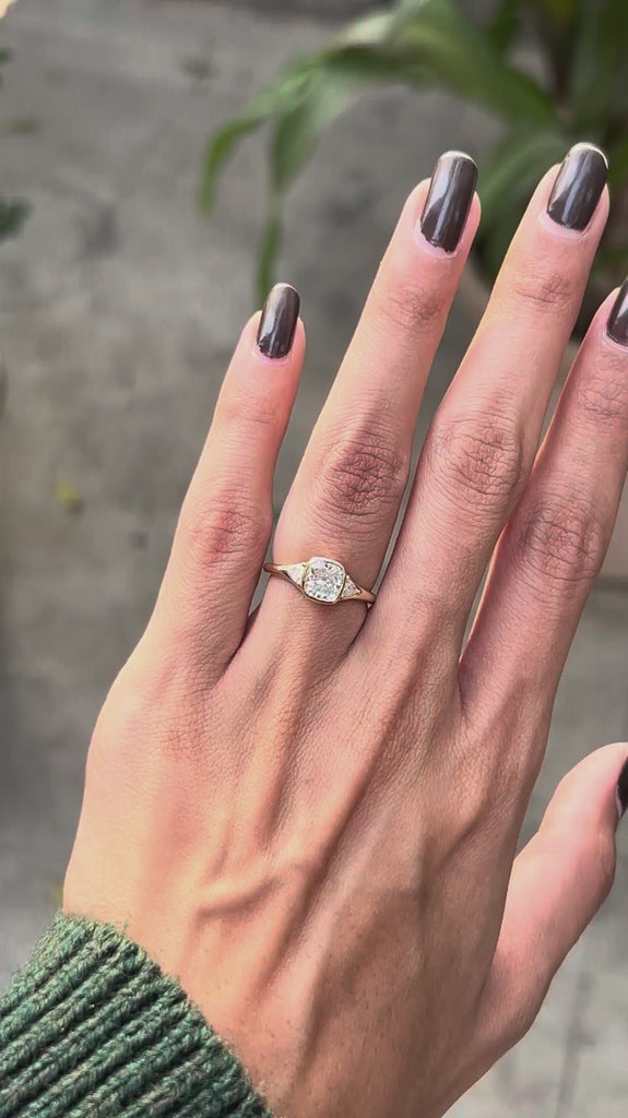 Cushion cut bezel set center stone engagement ring with prong set trillion accents