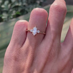 Delicate marquise center stone engagement ring with round side stones yellow gold video